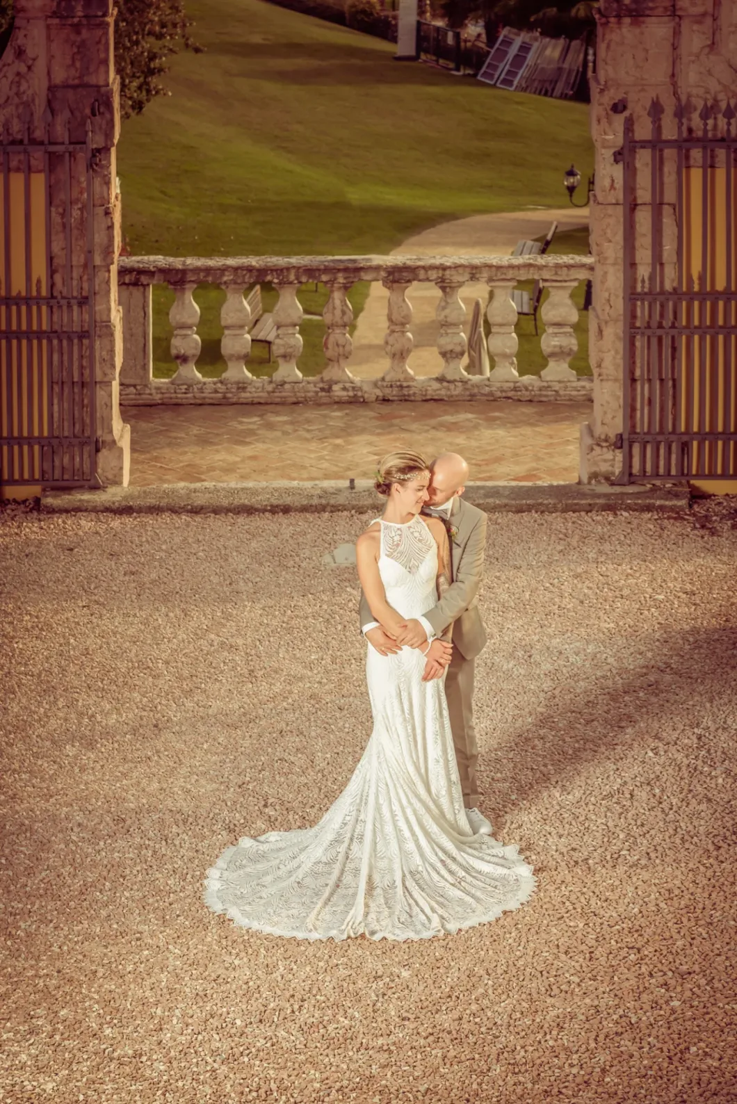 Brautpaar in eleganter Umgebung, Braut im weißen Kleid, Bräutigam im hellen Anzug.
